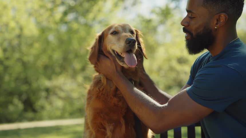 A man is petting his dog