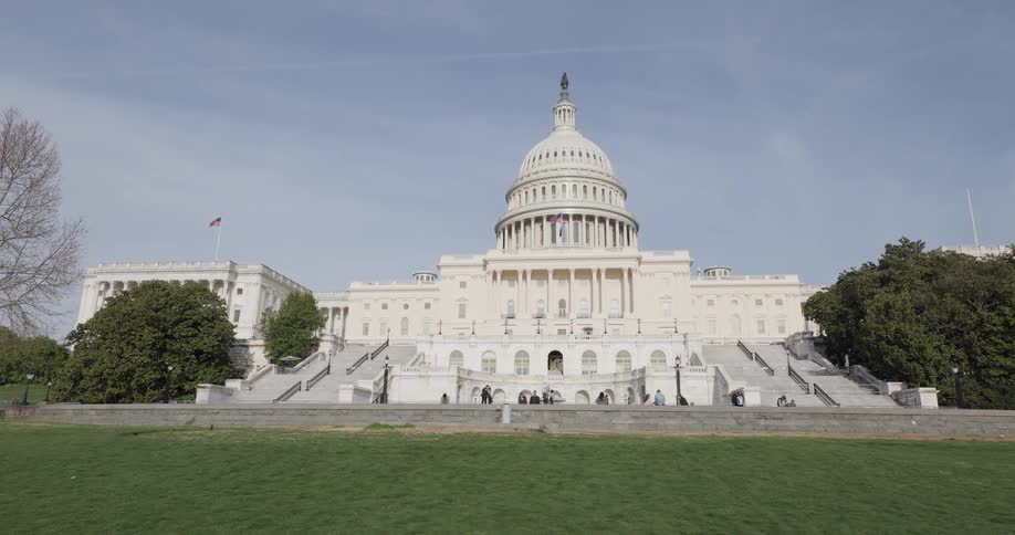 People walk past the capitol building
