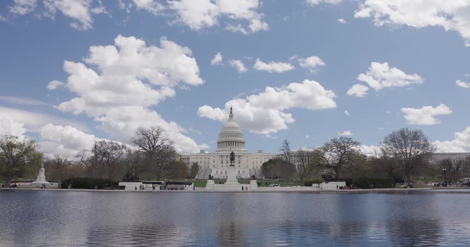 Panorama of a lake and the washington capitol in the background on a blue sky day with clouds