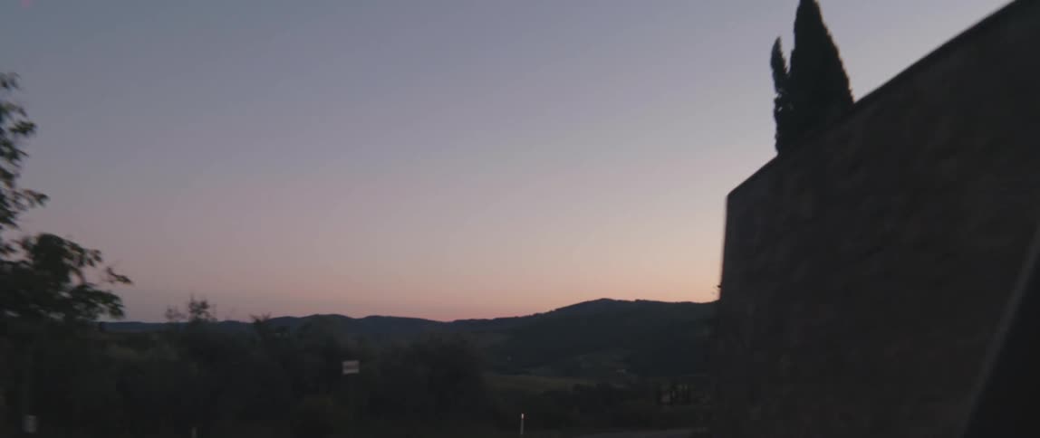 A vehicle is driving at sunset