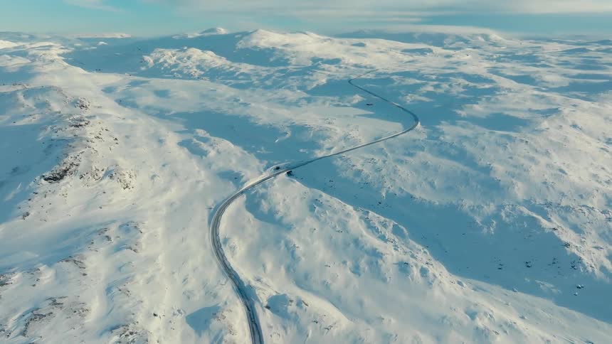 A thin river passing through a field covered in ice