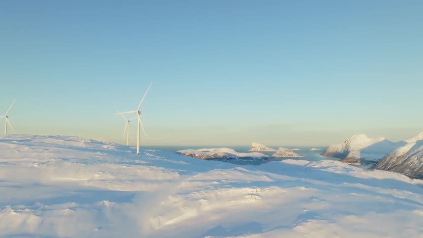 Aerial of wind turbines on snowy wind farm