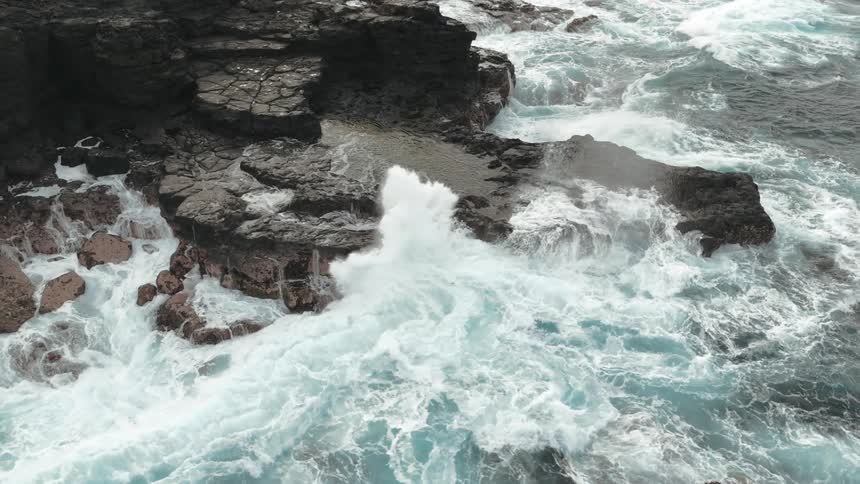 Huge waves slam a rocky shore
