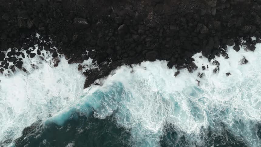 Big waves crash onto a rocky beach
