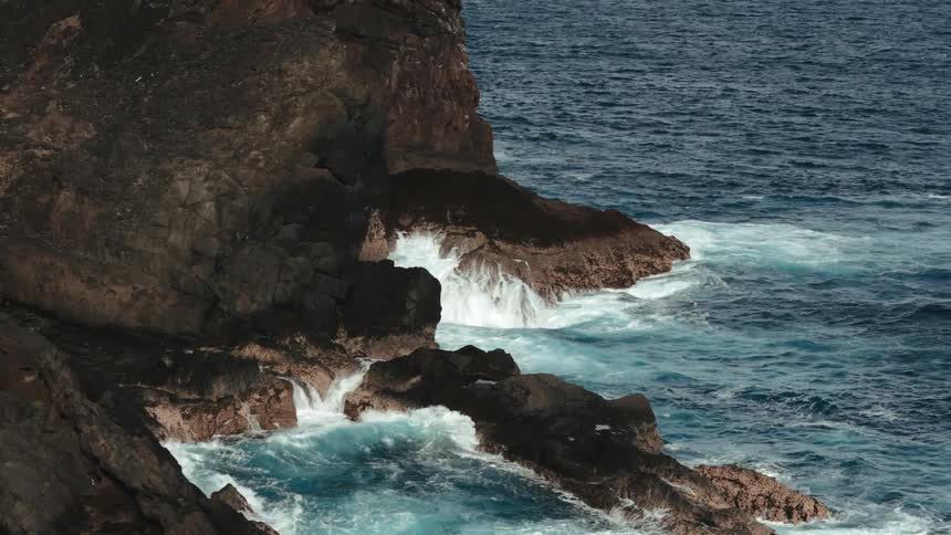 Waves crash into a rocky coast