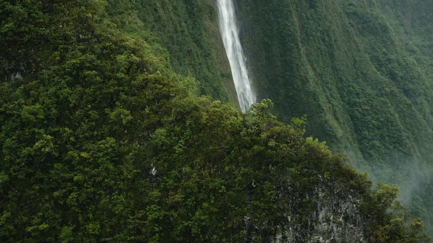 A clip of a waterfall in a mountainous aeria