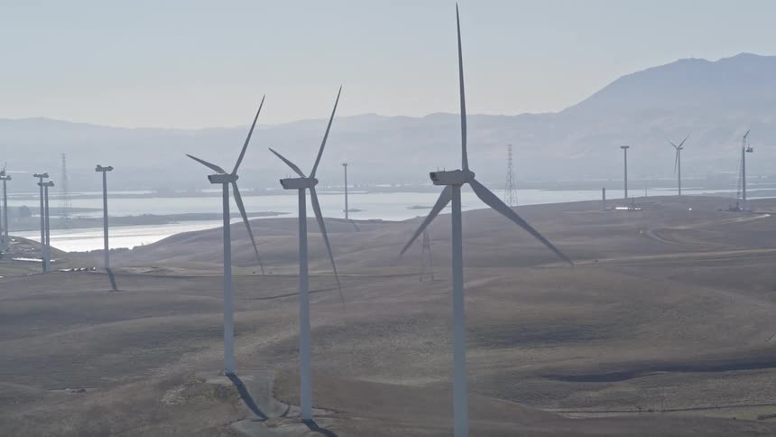 A wind turbine farm four turbines generating power several others are under construction