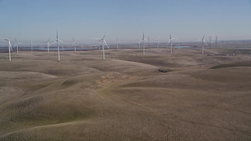 A wind farm on a big grassy plain