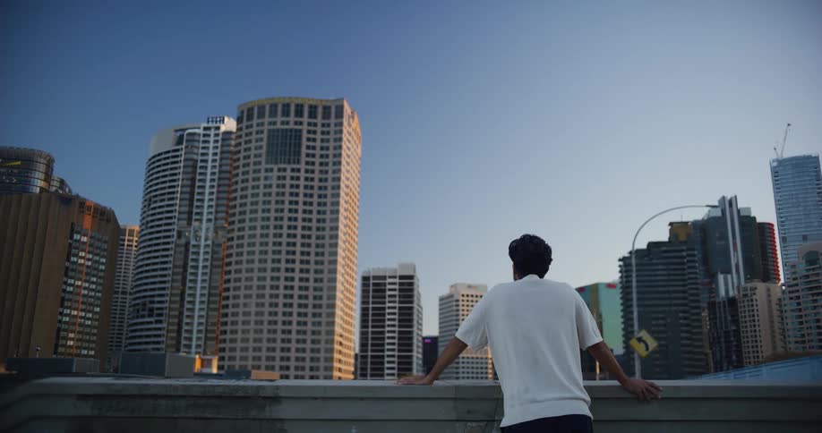 A man looks around at a city downtown