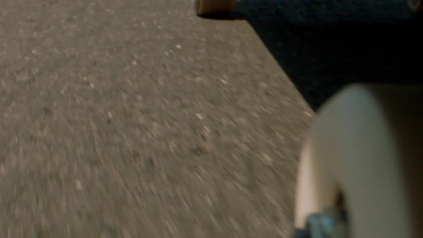 Skateboard moving across an asphalt