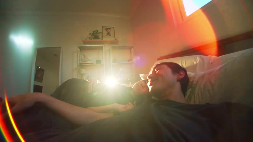 A man and woman lay in bed together