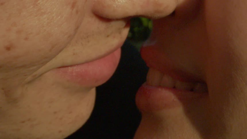 A man and a woman kiss