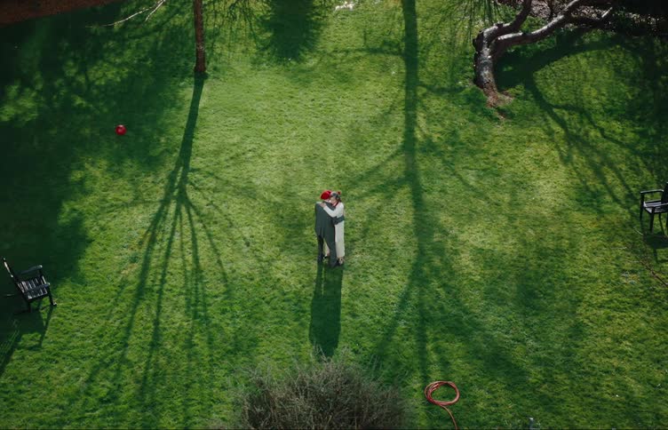 A couple are dancing on the grass