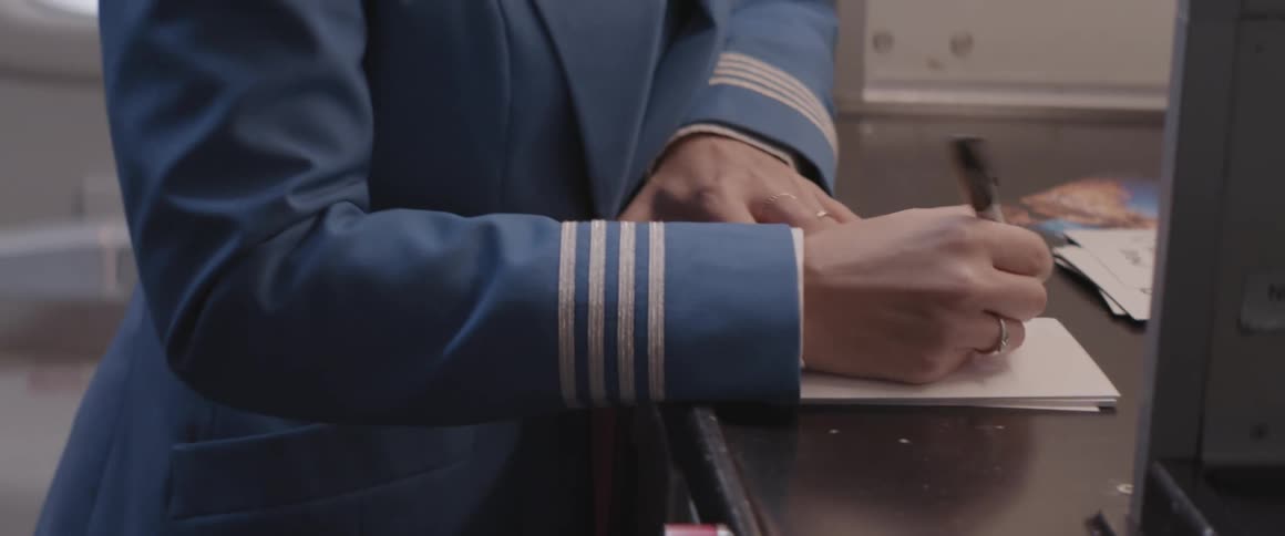An airline worker writes on a piece of paper