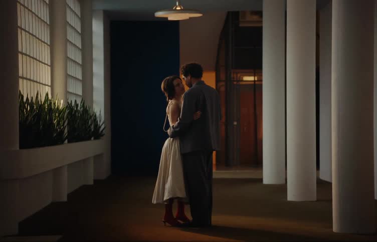 Couple embracing romantically in the lobby of a building