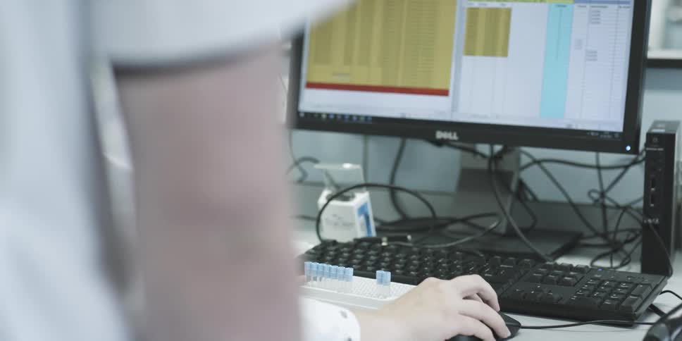 Two scientists in the laboratory analyzing data on a computer
