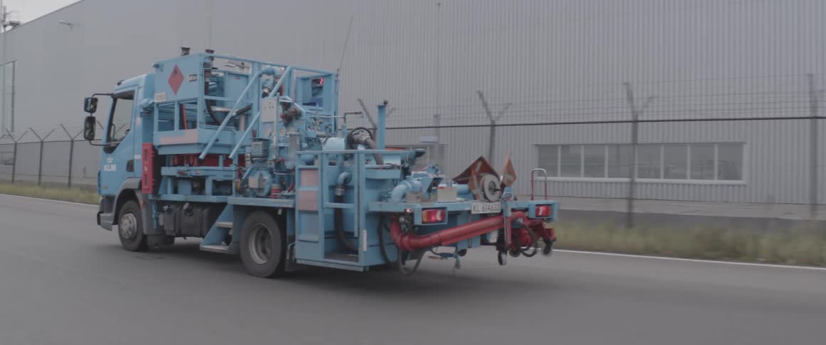 Gas distribution truck moving along a paved road