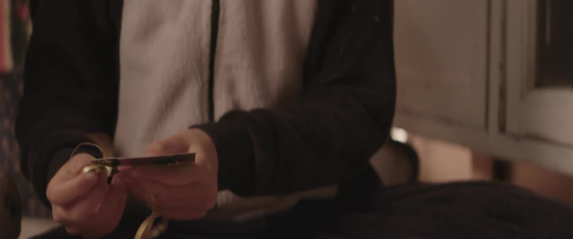 Hands of a boy picking up and opening a gift