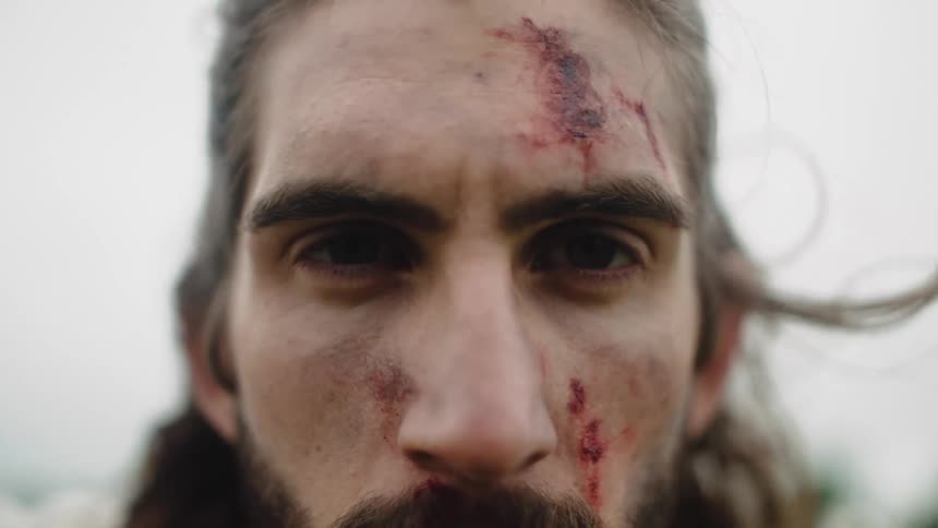 Slow motion mans face with cuts and bruises
