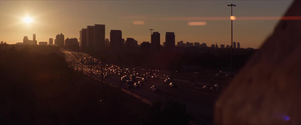 Heavy traffic travels near the city at sunset