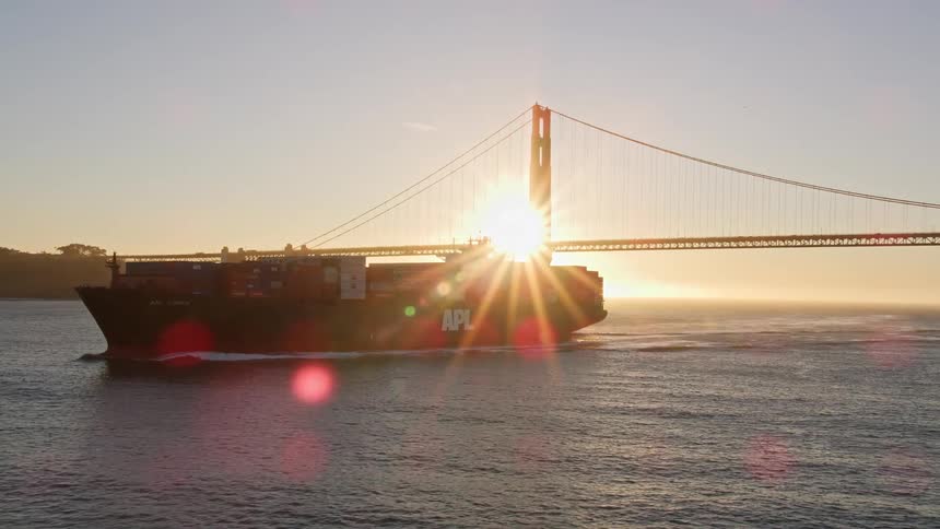 A ship transports storage containers on the river