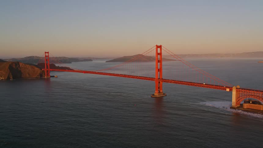 The golden gate bridge spans the entrance to a large bay