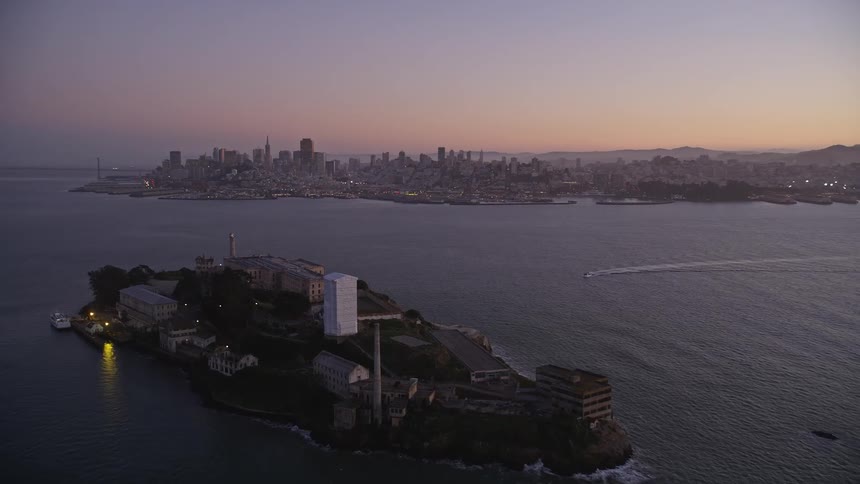 A small island is off the shore of the city