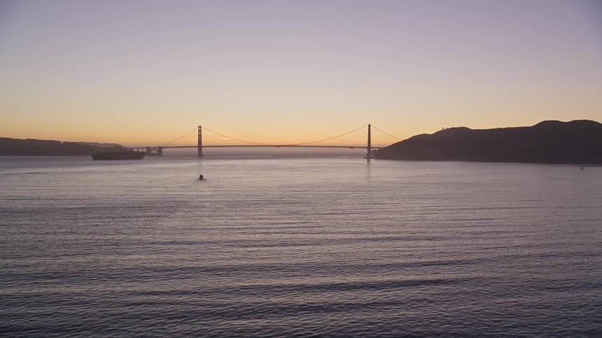 A large suspension bridge in the calm sea on a morning
