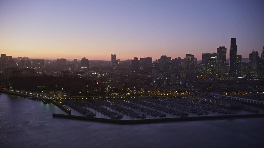 Aerial panorama of a seaside metropolis with docks and a purple sky day