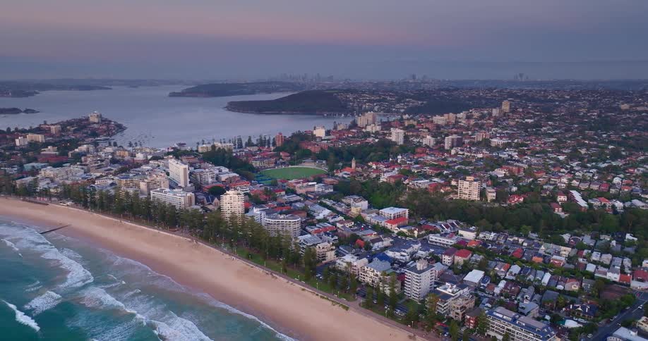 Aerial view of a coastal cityscape at dusk
