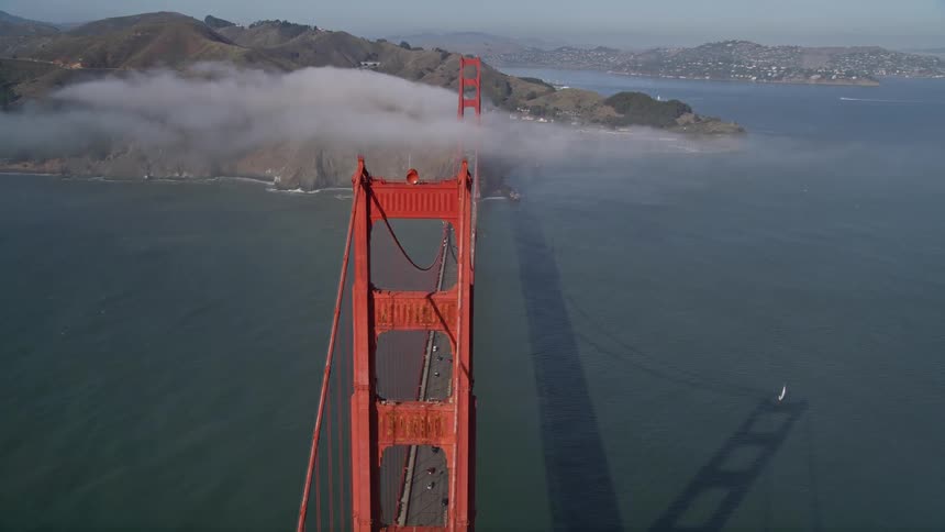 The clouds sit on the long red bridge