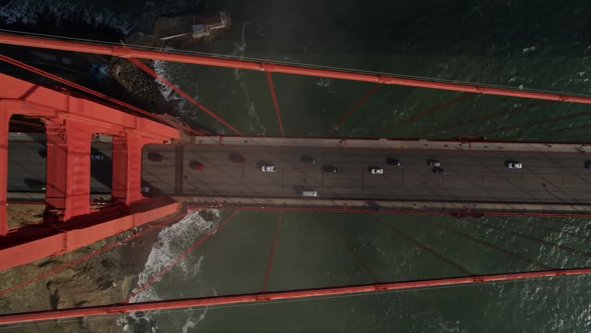 Top view of a long bridge over the sea with vehicle traffic