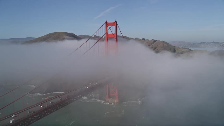 Aerial panorama of golden gate bridge with vehicle traffic and fog during daytime