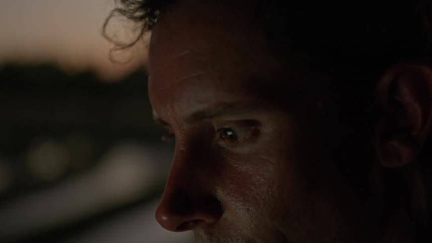 Side portrait of a man with light reflecting on his face