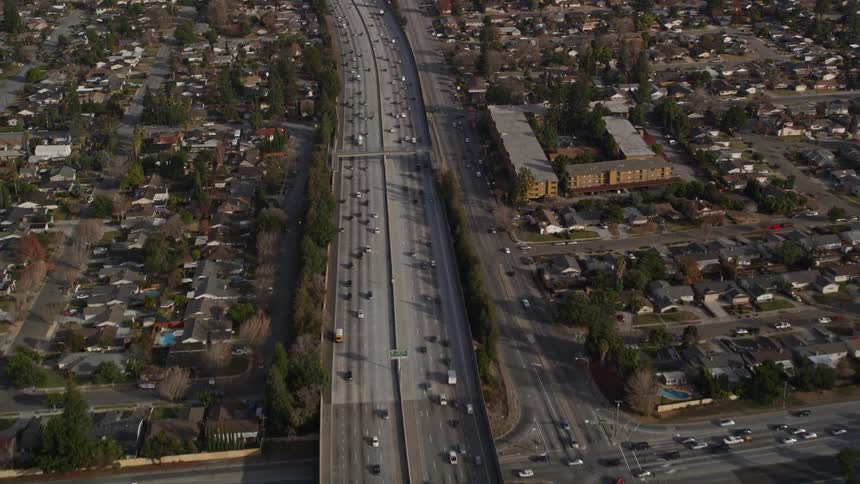 Aerial panorama of an urban city with vehicle traffic through highway intersections