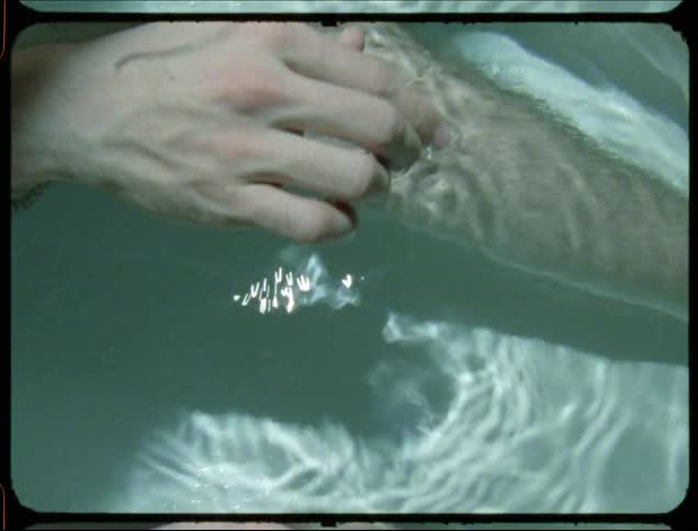 Closeup of a mans hand in the water