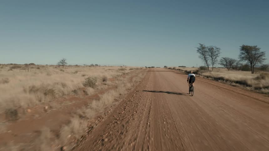 A clip of a person cycling in the desert