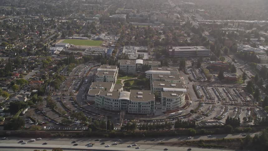 Top view of residential buildings and houses with a highway in front with vehicle traffic