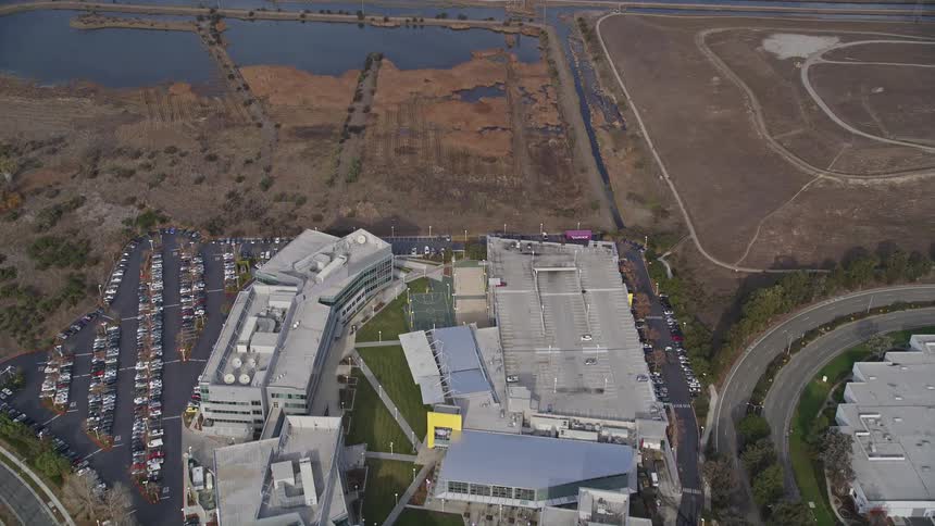 Nature sits next to large business facilities and buildings