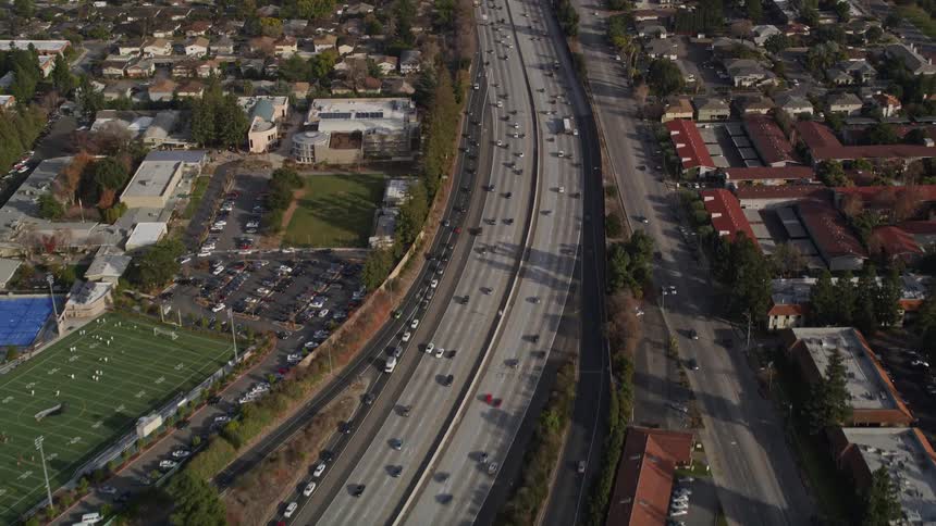Heavy traffic moves through a suburban area