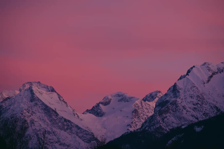 Mountain range under a pink sky at dusk
