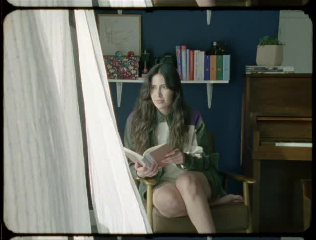 A clip of a lady reading in the room