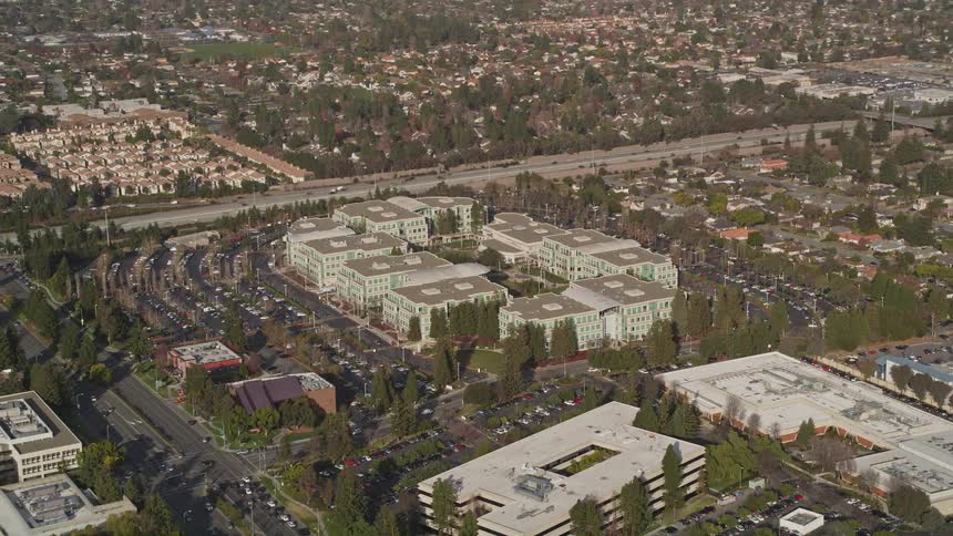 Aerial panorama of an urban area with buildings and houses and residential neighborhoods with intersections and vehicle traffic