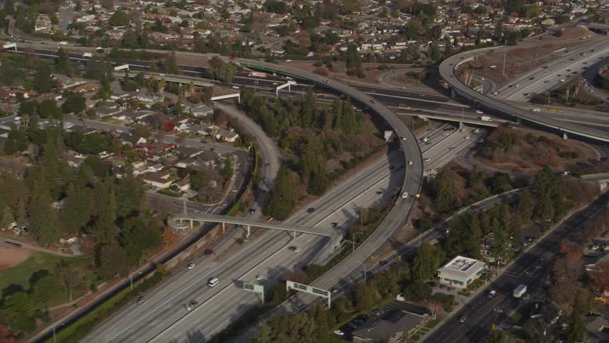 Traffic runs on the freeway through the suburbs