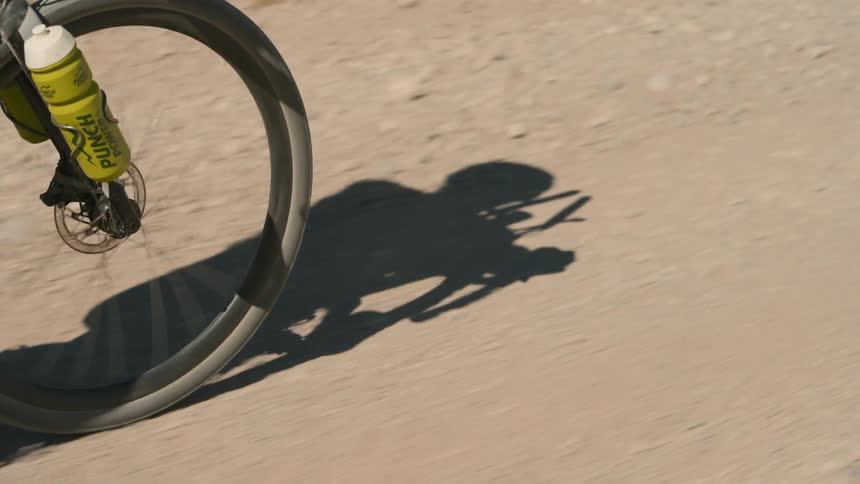 A person is riding their bike through the dirt