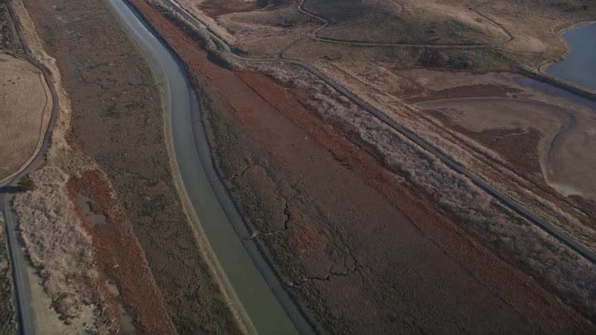 An aerial view of a region with small hills and rivers
