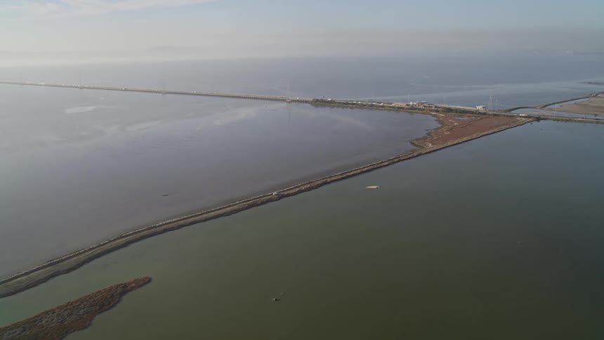 Vehicles drive on the road over the water