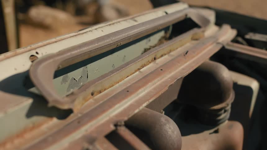 Closeup of a crack in a rusty vehicle