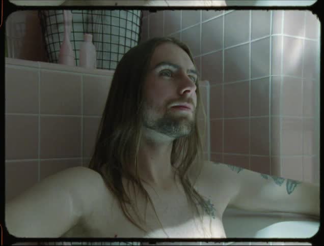 A man is sitting in the bathtub
