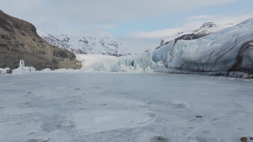 A glacier fills a large mountain valley